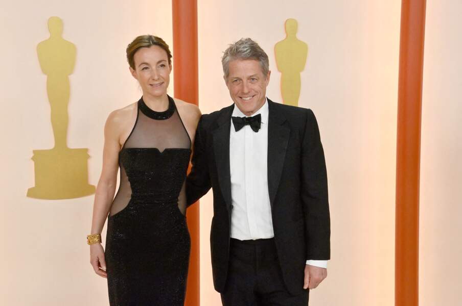 Hugh Grant et sa femme, la productrice Anna Eberstein,  posent tout sourire lors de la 95ème cérémonie des oscars le 12 mars 2023  