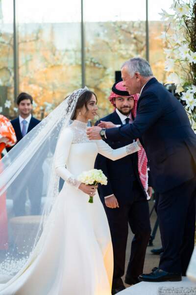 La princesse Iman de Jordanie embrasse son père, le roi Abdallah II, lors de son mariage à Amman le 12 mars 2023