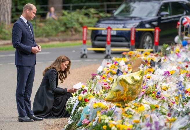 Le prince William et Kate Middleton regardent les hommages floraux laissés aux portes de Sandringham House à Norfolk.