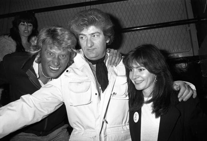 Eddy Mitchell sa femme Muriel et Johnny Hallyday à l'anniversaire de création du Golf Drouot, le "Temple du Rock" à Paris, en 1980