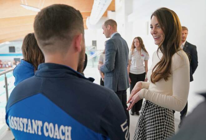 Kate Middleton rigole avec un coach présent lors de leur visite d'un centre de fitness à Port Talbot, au Pays de Galles, le 28 février 2023