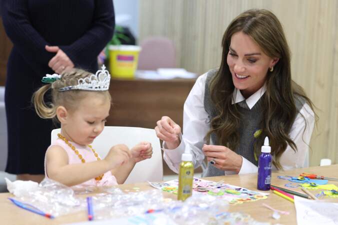 Kate Middleton aide une jeune fille lors d'une séance d'art et d'artisanat au cours d'une visite au centre communautaire Vsi Razom.