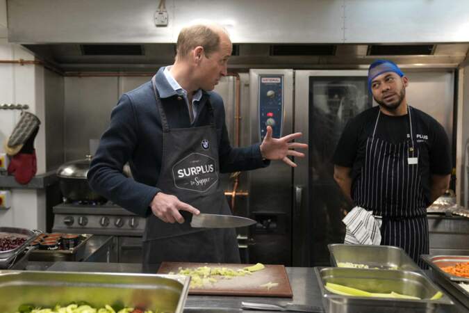 Le prince de Galles coupe du céleri tout en aidant à préparer une sauce bolognaise.